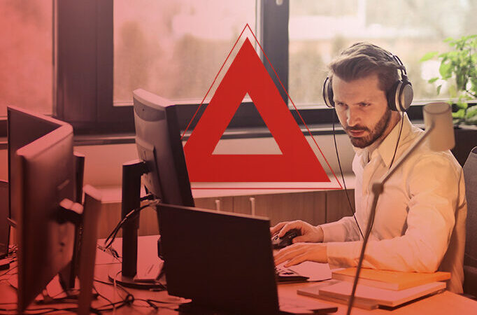 man-working-at-desk-with-headphones-on